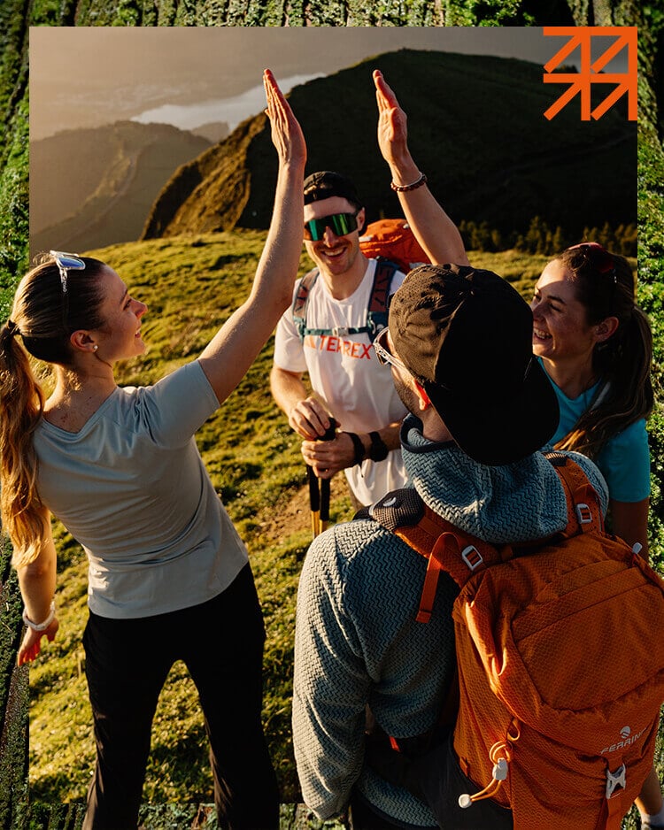 Gruppo di ragazzi che fa trekking in montagna al tramonto